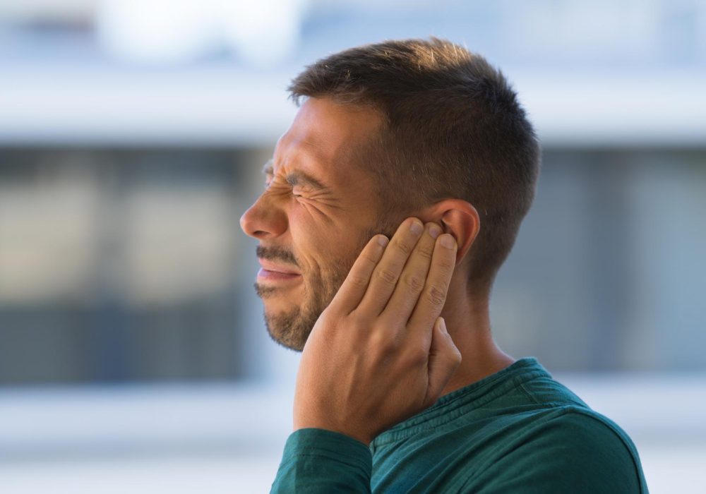 otitis-or-tinnitus-man-touching-his-ear-because-of-strong-earache-or-ear-pain-high-quality-photo.jpg