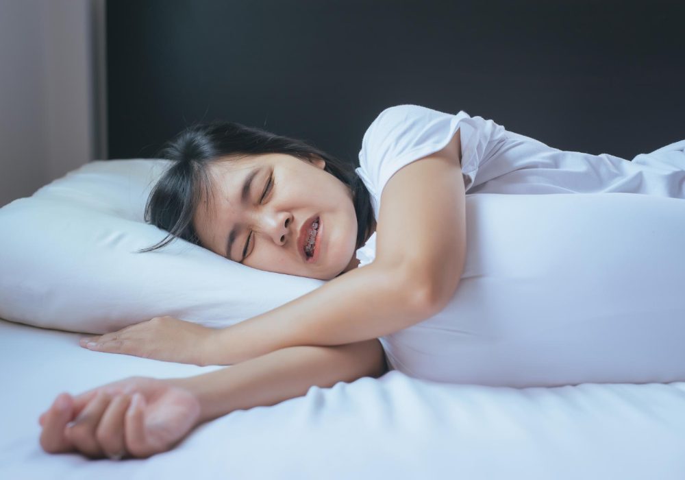 woman-sleeping-on-the-bed-and-grinding-teethtiredness-and-stress.jpg